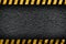 Grunge dark grey background with warning stripes