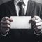 Grunge elegance Close up of a businessman holding a blank card