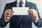 Grunge elegance Close up of a businessman holding a blank card