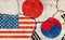 Grunge flags illustration of three countries with conflict and political problems cracked concrete background | USA, Japan and