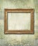 Grunge floral faded wallpaper with golden antique empty frame