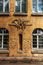 Grunge freemasonry emblem on a dramatic background - masonic triangle and compass, closeup of old architectural building