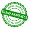 Grunge green brand awareness word round rubber stamp on white background