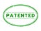 Grunge green patented word oval rubber stamp on white background