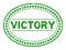Grunge green victory word oval rubber stamp on white background