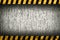 Grunge grey wall background with warning stripes