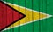 Grunge Guyana Flag Over Wood Planks