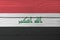 Grunge Iraqi flag texture, a horizontal tricolor of red white and black with the â€œGod is greatest` in green.