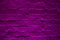 Grunge neon purple brick wall texture background. Magenta colored brick wall texture architexture pattern