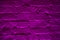 Grunge neon purple brick wall texture background. Magenta colored brick wall texture architexture pattern