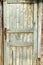 Grunge pastel red tint wood planks of the door texture background