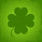 Grunge poster with four leaf Irich clover. St Patrick day green scratched placard