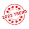 Grunge red 2023 trend word with star icon round rubber stamp on white background