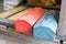 Grunge red and blue metal tool boxes on wood palette in factory