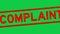 Grunge red complaint word square rubber stamp zoom in green background