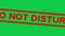 Grunge red do not disturb word square rubber stamp zoom in green background