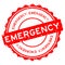 Grunge red emergency word round rubber stamp on white background