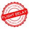 Grunge red flight delay word round rubber stamp on white background