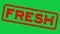 Grunge red fresh word square rubber stamp zoom on green background