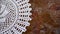 Grunge rustic background with crocheted doily on old iron surface