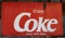 Grunge rusty retro vintage Coca-Cola metal board sign.