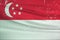 Grunge Singapore flag. Singapore flag with waving grunge texture.