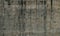 Grunge texture for background, gray wall in black smudges with climbing hooks. Fragment of a wall in, Calella, Spain