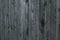 Grunge texture of gray old wooden fence. Gray background of shabby wooden boards, planks. Surface of old shabby weathered wooden p