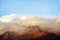 Grunge textured mountain range in the clouds