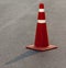 Grunge traffic cone with double white stripe on the street