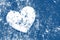 Grunge white heart on distressed dark blue background