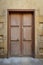 Grunge wooden aged door on grunge stone bricks wall