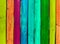 Grunge wooden colored background - paint a rainbow on old fence