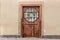 Grunge wooden door with hexagonal glass window
