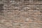 Grungy brown brick texture with darker spots