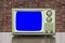 Grungy Green Vintage Television with Brick Wall and Chroma Key Blue Screen