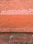 Grungy industrial urban painted red brick wall