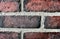 Grungy old red brick wall texture background with deterioration from age