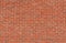 Grungy old red brick wall texture background with deterioration from age