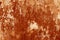 Grungy rusted metal wall surface in orange tone