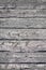 Grungy weathered horizontal black painted barn boards on an old