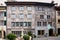 Gruyere, Switzerland - May, 2017: The street of old town touristic place, with painted with fresco ancient houses.