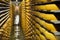 Gruyeres, Switzerland - July 27, 2019: Cheese wheels maturing in the cellar storage of the famous Swiss cheese factory La Maison