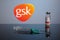 GSK Logo with Covid Vaccine Set of Inoculation Syringe and GlaxoSmithKline Vaccine