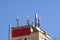 GSM transmitters on a roof of white administrative building. Close up