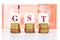 GST or Good and Services Tax concept with stack of coin and currency