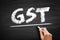 GST Goods and Service Tax - indirect tax on the supply of goods and services, acronym text on blackboard