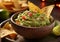 Guacamole avocado dip with corn nachos on dark background.Macro.AI Generative