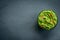 Guacamole bowl on a stone table. Top view image. Copyspace for your text.