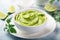 Guacamole, mexican avocado dip, in white bowl